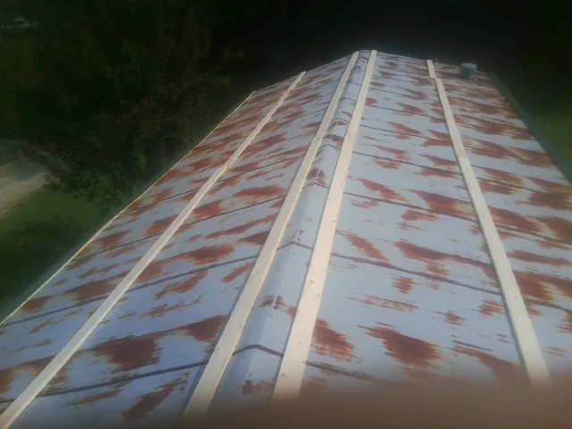 Rusted metal roof panels with new wood purlins before replacement — Storm Damage Roof Repair in Intercourse by Roofing Brothers